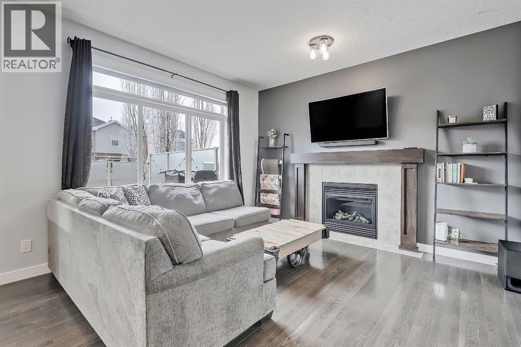 Perfect sized living area - 9 Copperleaf Way Se, Calgary, AB - Indoor Photo Showing Living Room With Fireplace