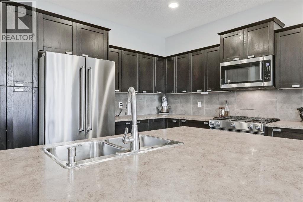 Drinking water system - 9 Copperleaf Way Se, Calgary, AB - Indoor Photo Showing Kitchen With Stainless Steel Kitchen With Double Sink With Upgraded Kitchen
