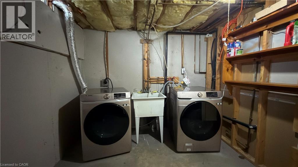 Laundry area with concrete flooring and separate washer and dryer - 66 Glamis Road Unit# 33, Cambridge, ON - Indoor Photo Showing Laundry Room