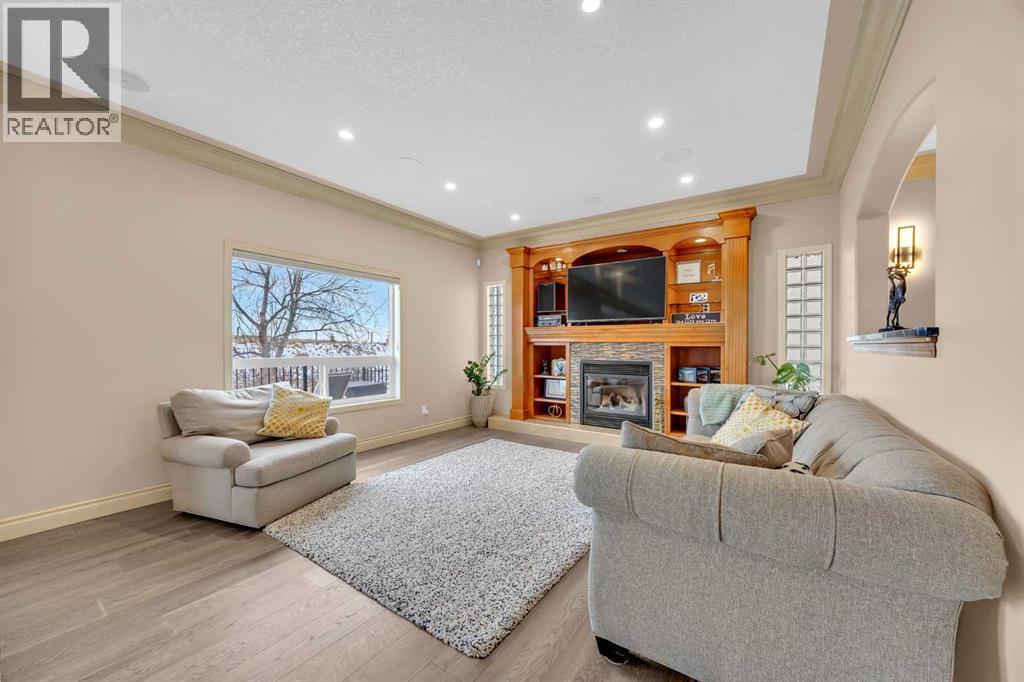 100 Cougarstone Manor Sw, Calgary, AB - Indoor Photo Showing Living Room With Fireplace