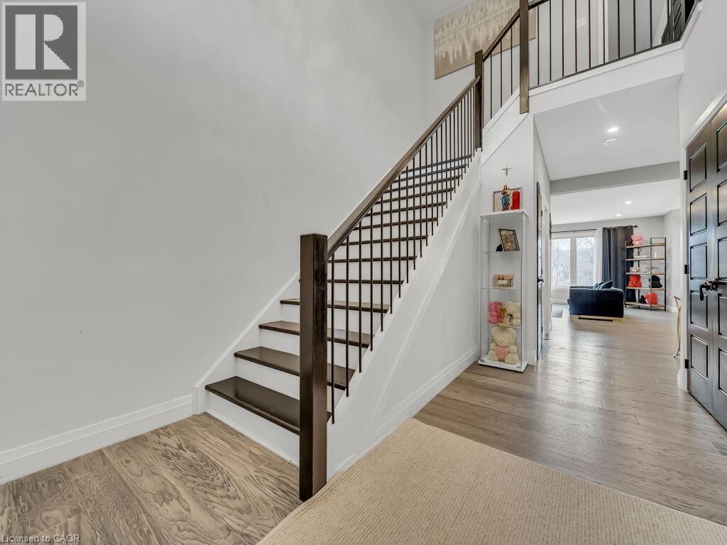 Stairway with wood finished floors, a towering ceiling, and recessed lighting - 3374 Oriole Drive, London, ON - Indoor Photo Showing Other Room