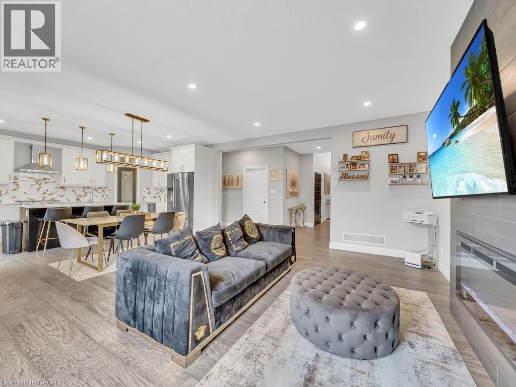 Living room featuring light wood-type flooring and recessed lighting - 3374 Oriole Drive, London, ON - Indoor Photo Showing Living Room With Fireplace