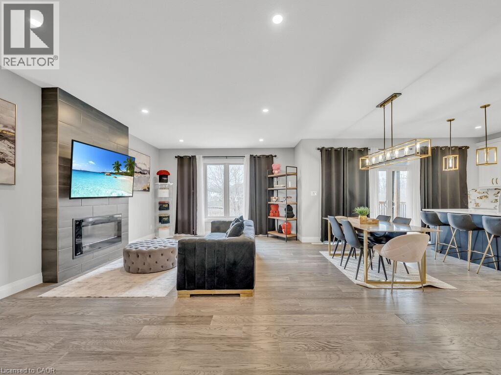 Living area with light wood-style flooring, a fireplace, and recessed lighting - 3374 Oriole Drive, London, ON - Indoor Photo Showing Other Room With Fireplace