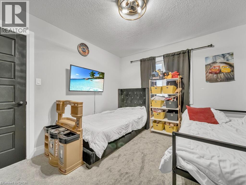 Bedroom with carpet flooring and a textured ceiling - 3374 Oriole Drive, London, ON - Indoor Photo Showing Bedroom