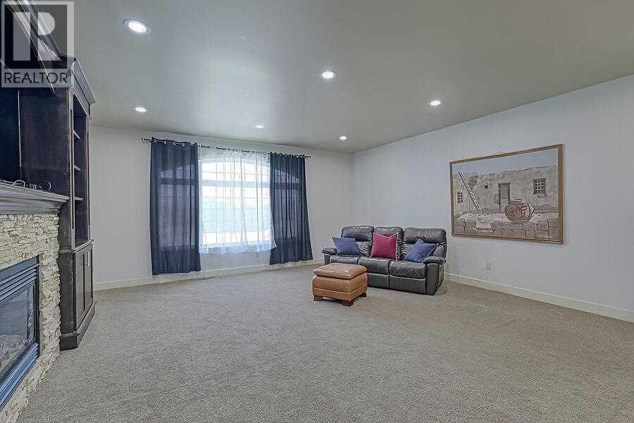 16 Rockcliff Point Nw, Calgary, AB - Indoor Photo Showing Living Room With Fireplace