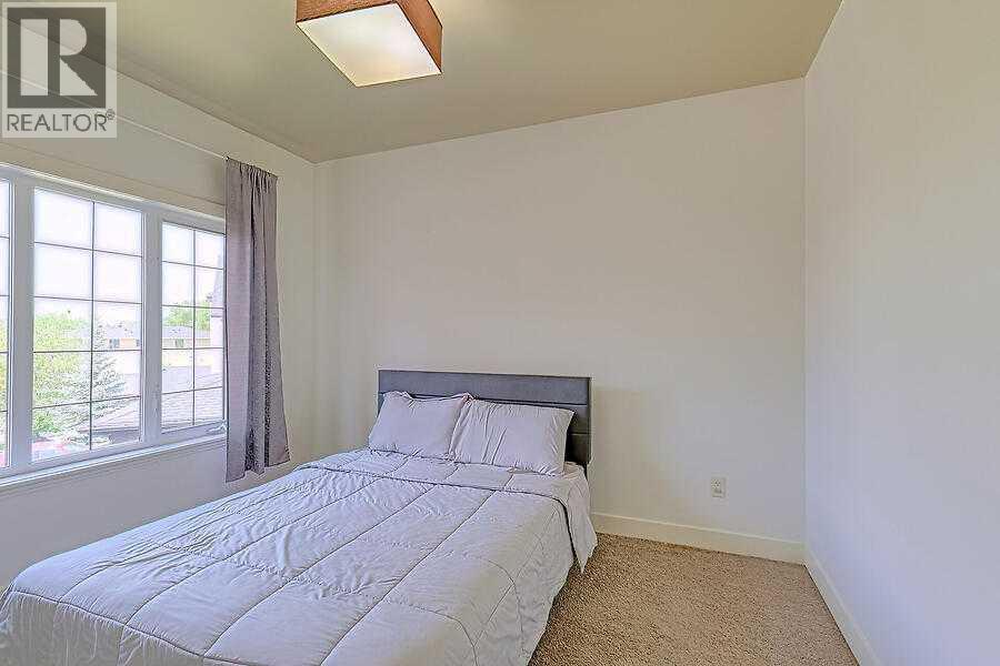 16 Rockcliff Point Nw, Calgary, AB - Indoor Photo Showing Bedroom