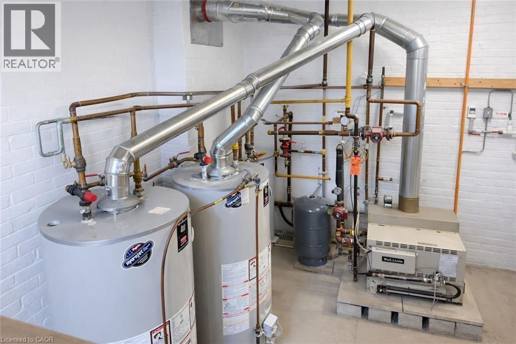 Utility room with water heater - 17 Louisa Street, Kitchener, ON - Indoor Photo Showing Basement