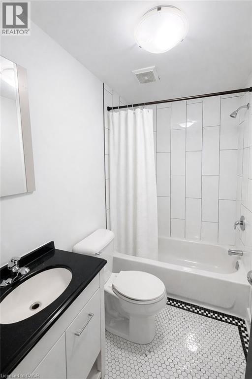 Full bath featuring vanity, shower / tub combo, and light tile patterned flooring - 112 Margaret Avenue, Kitchener, ON - Indoor Photo Showing Bathroom
