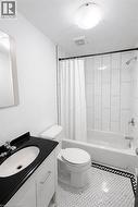 Full bath featuring vanity, shower / tub combo, and light tile patterned flooring -