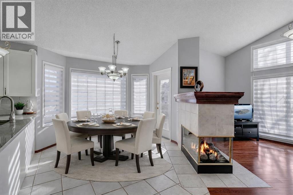 78 Mckenzie Lake Place Se, Calgary, AB - Indoor Photo Showing Dining Room With Fireplace