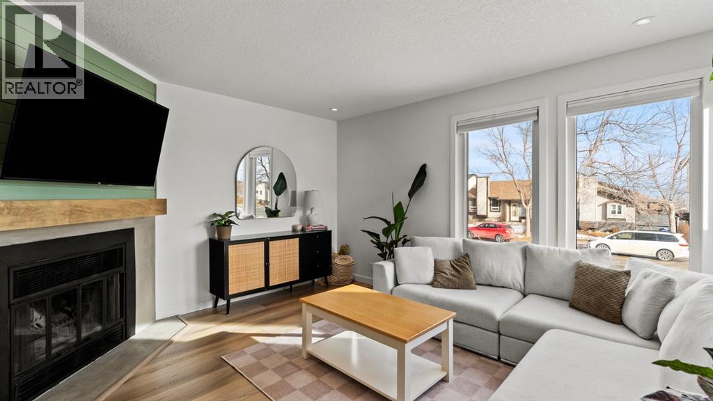 161 Macewan Glen Drive Nw, Calgary, AB - Indoor Photo Showing Living Room With Fireplace