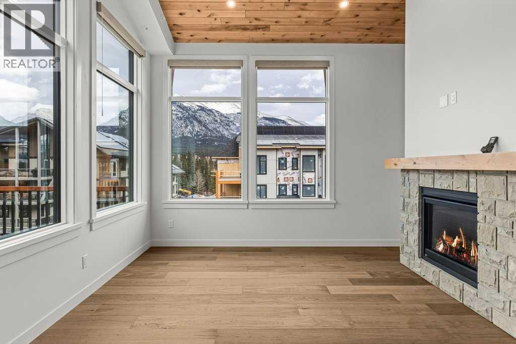 407, 1505 Spring Creek Gate, Canmore, AB - Indoor With Fireplace