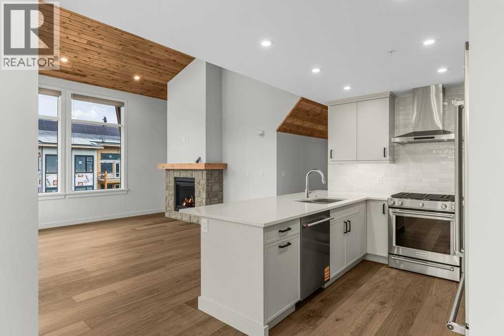 407, 1505 Spring Creek Gate, Canmore, AB - Indoor Photo Showing Kitchen With Upgraded Kitchen