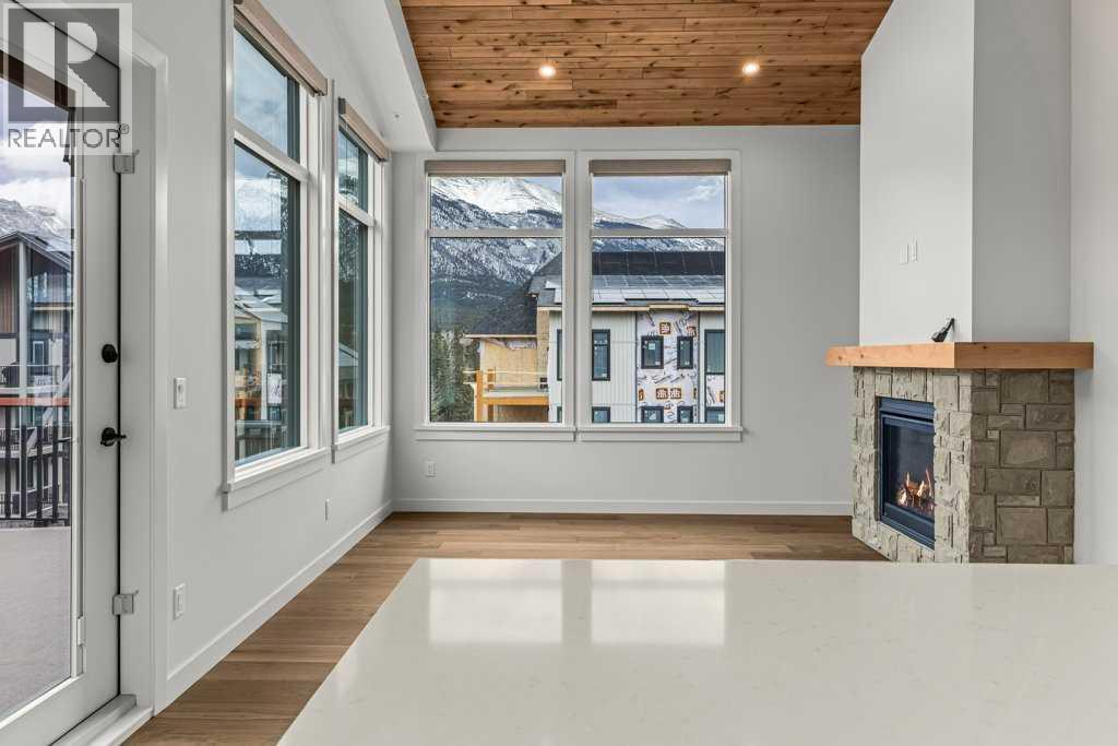 407, 1505 Spring Creek Gate, Canmore, AB - Indoor With Fireplace