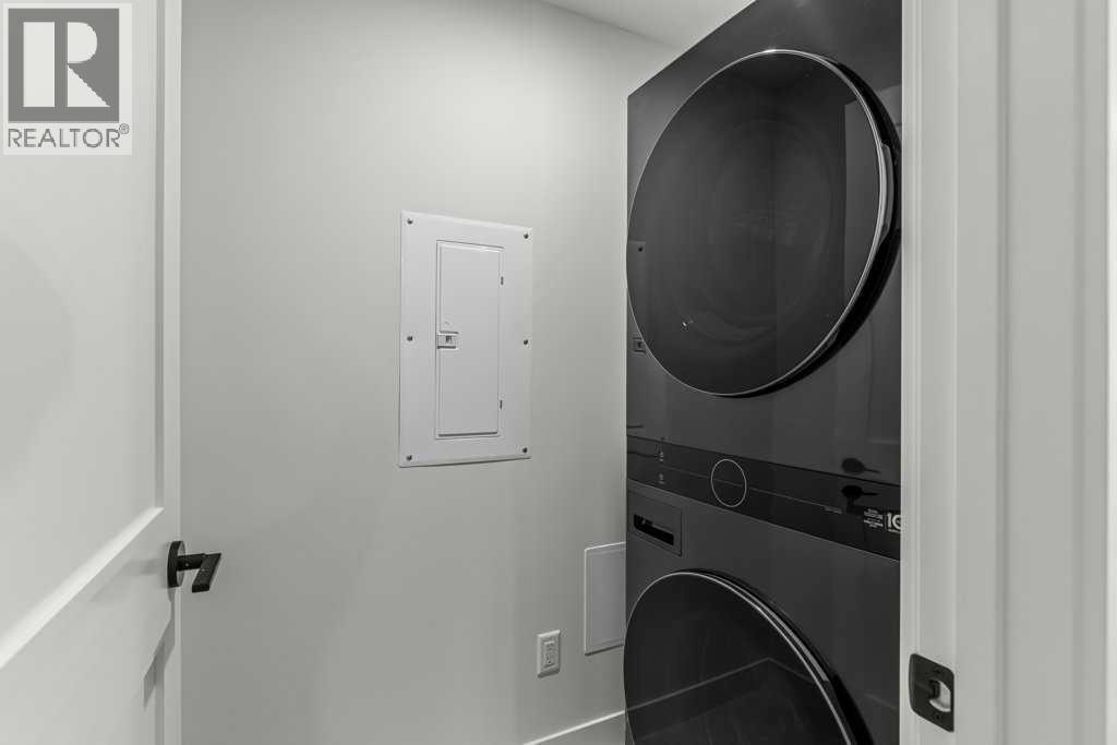 407, 1505 Spring Creek Gate, Canmore, AB - Indoor Photo Showing Laundry Room