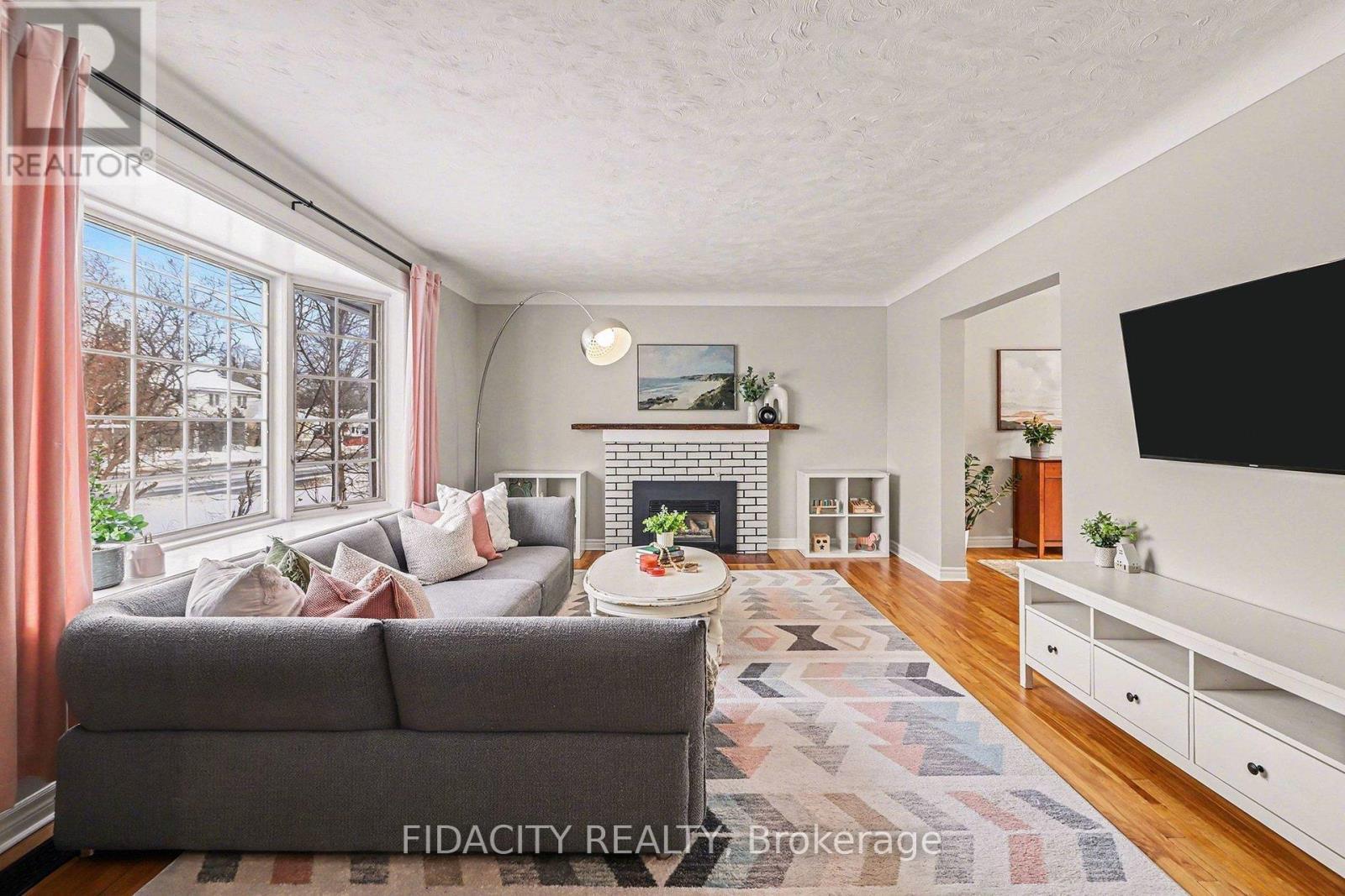 758 Smyth Road, Ottawa, ON - Indoor Photo Showing Living Room With Fireplace