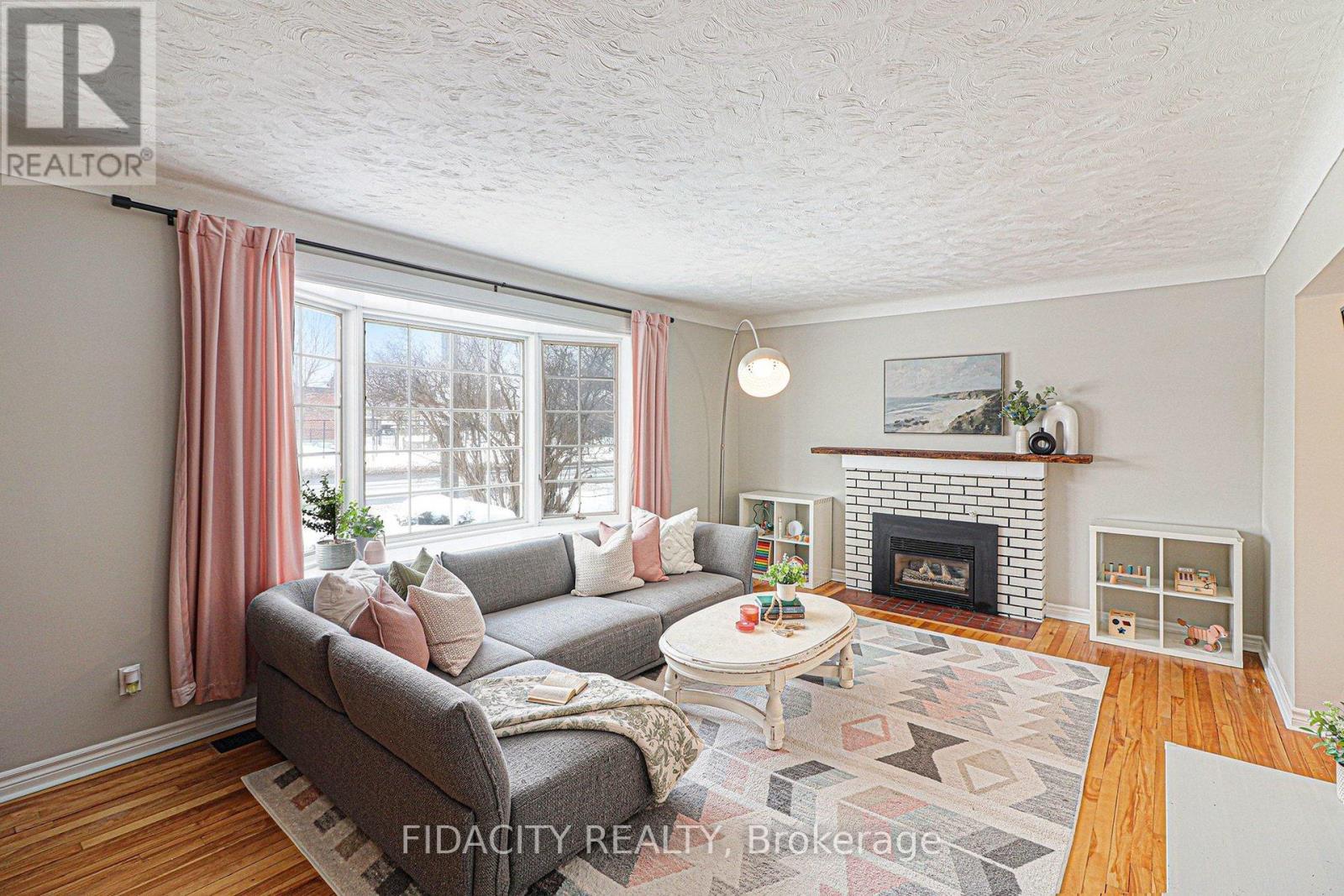 758 Smyth Road, Ottawa, ON - Indoor Photo Showing Living Room With Fireplace