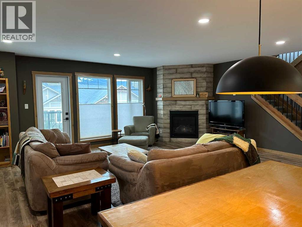 67 Ironstone Drive, Coleman, AB - Indoor Photo Showing Living Room With Fireplace