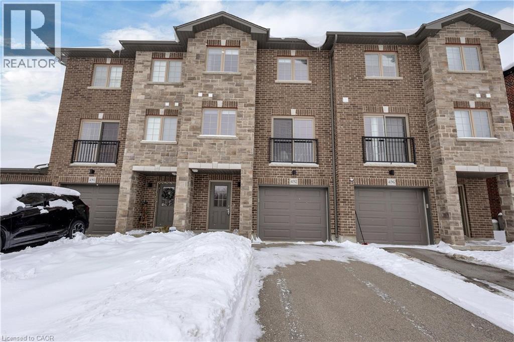 Traditional-style house with an attached garage, brick siding, and driveway - 492 Wismer Street, Waterloo, ON - Outdoor With Facade