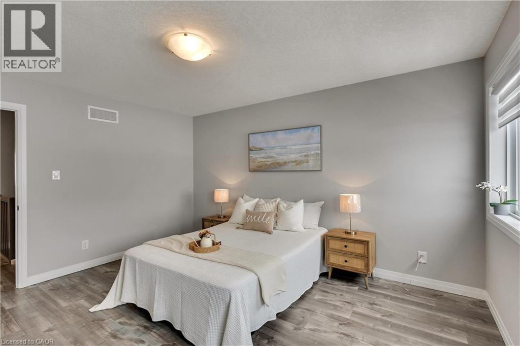 Bedroom with light wood-type flooring and a textured ceiling - 492 Wismer Street, Waterloo, ON - Indoor Photo Showing Bedroom