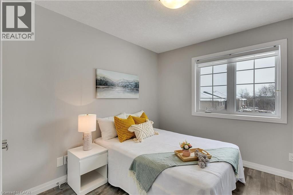 Bedroom featuring dark wood-style floors and a textured ceiling - 492 Wismer Street, Waterloo, ON - Indoor Photo Showing Bedroom