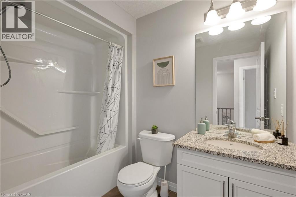 Bathroom with vanity and shower / bath combination with curtain - 492 Wismer Street, Waterloo, ON - Indoor Photo Showing Bathroom