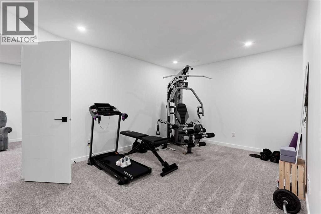 668 Aquitania Boulevard W, Lethbridge, AB - Indoor Photo Showing Gym Room