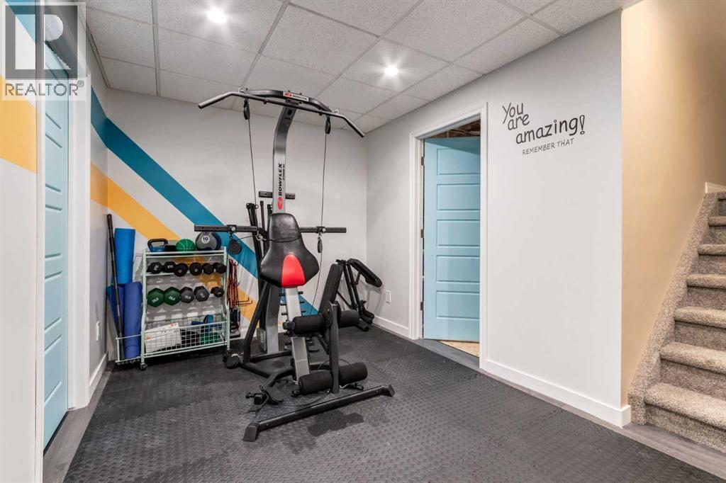 26 Mount Rae Terrace, Okotoks, AB - Indoor Photo Showing Gym Room