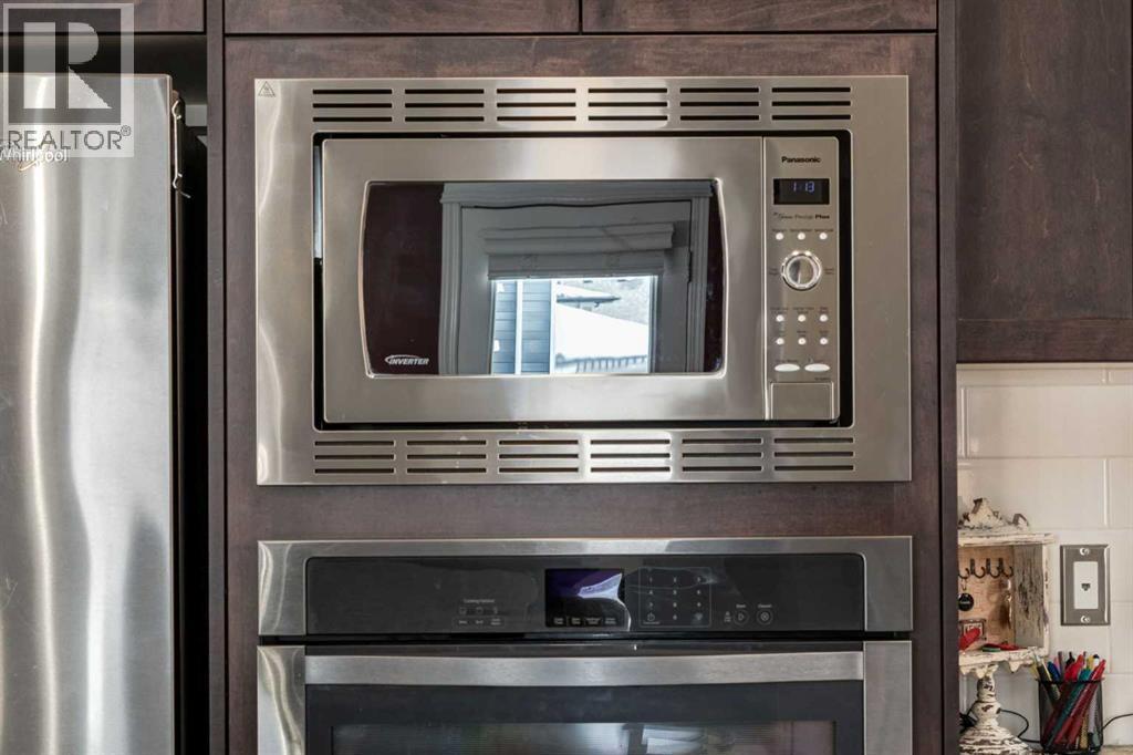 26 Mount Rae Terrace, Okotoks, AB - Indoor Photo Showing Kitchen With Stainless Steel Kitchen