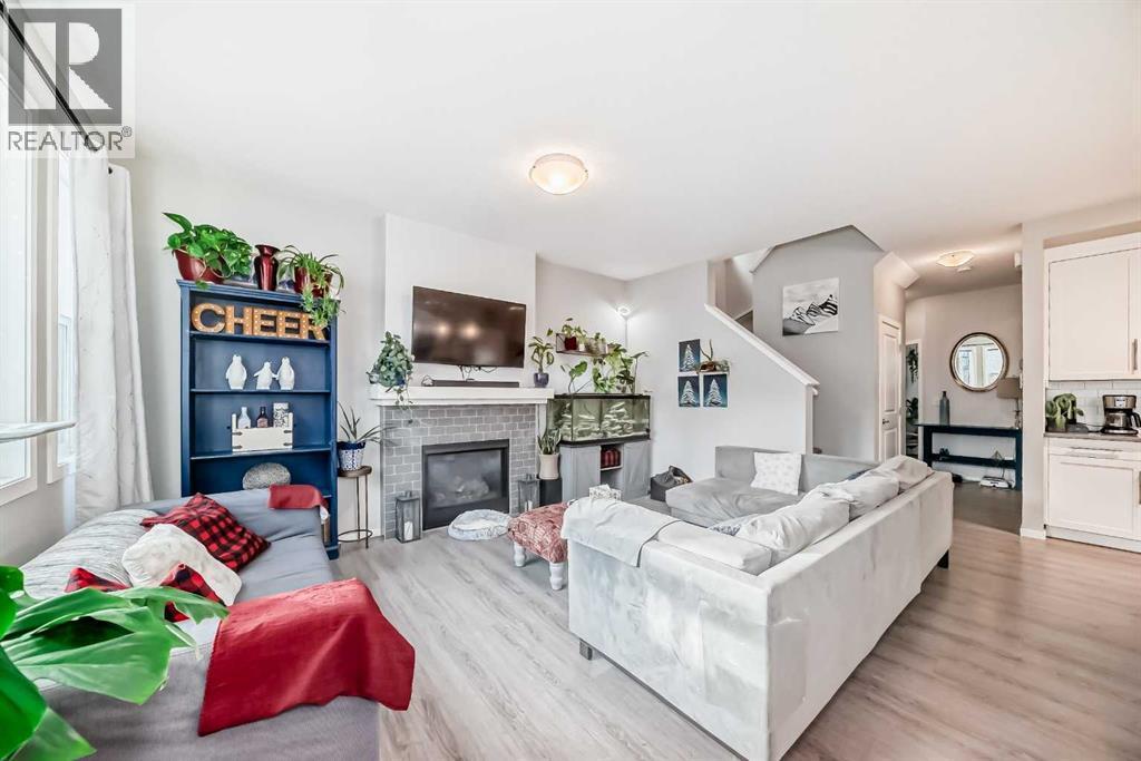 325 Sundown View, Cochrane, AB - Indoor Photo Showing Living Room With Fireplace