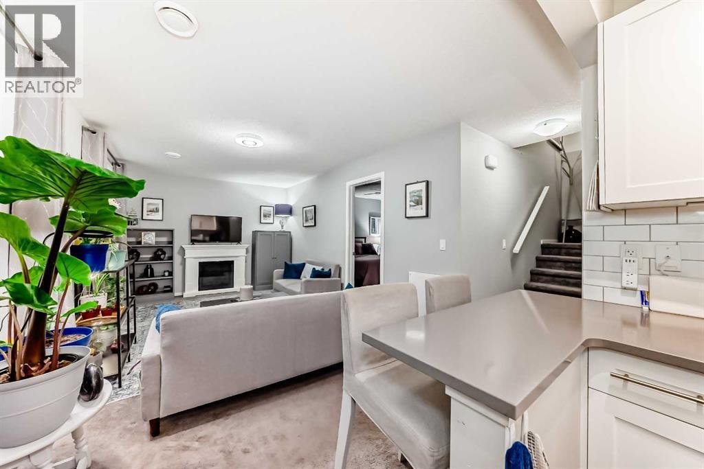 325 Sundown View, Cochrane, AB - Indoor Photo Showing Living Room With Fireplace