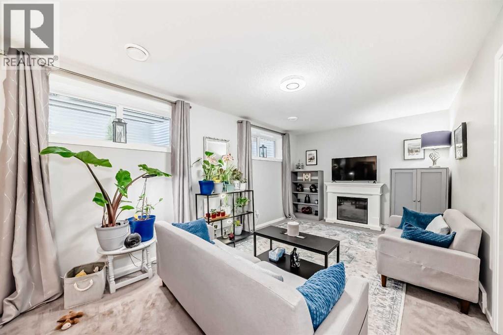 325 Sundown View, Cochrane, AB - Indoor Photo Showing Living Room With Fireplace