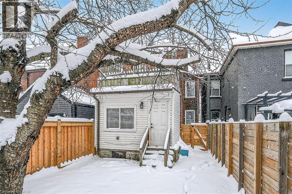 Snow covered property with a fenced backyard, a gate, and entry steps - 77 Barton Street E Unit# 1, Hamilton, ON - Outdoor