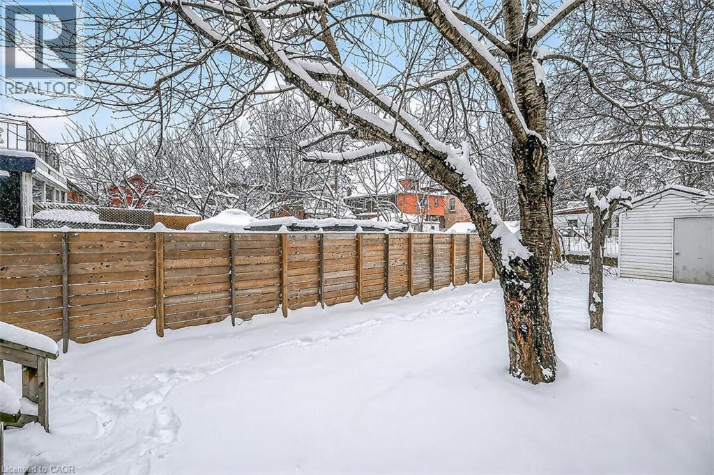 Snowy yard featuring a storage shed - 77 Barton Street E Unit# 1, Hamilton, ON - Outdoor