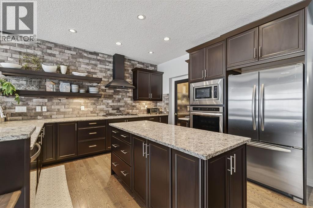 105 Riviera Crescent, Cochrane, AB - Indoor Photo Showing Kitchen With Stainless Steel Kitchen With Upgraded Kitchen