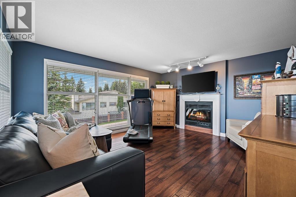 103 Stratton Park Sw, Calgary, AB - Indoor Photo Showing Living Room With Fireplace