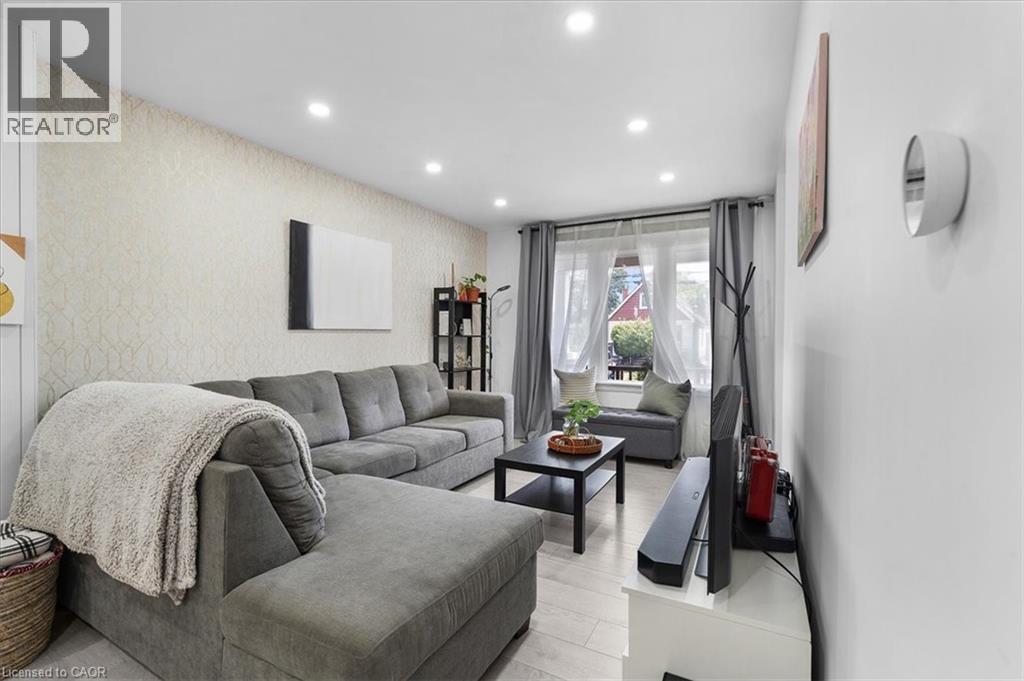 Living room featuring wallpapered walls, recessed lighting, an accent wall, and light wood finished floors - 133 Frederick Avenue, Hamilton, ON - Indoor Photo Showing Other Room