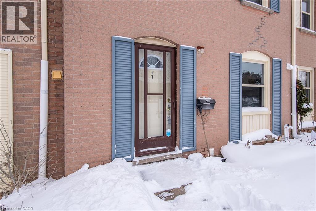 Snow covered property entrance featuring brick siding - 27 Queenston Drive, Kitchener, ON - Outdoor