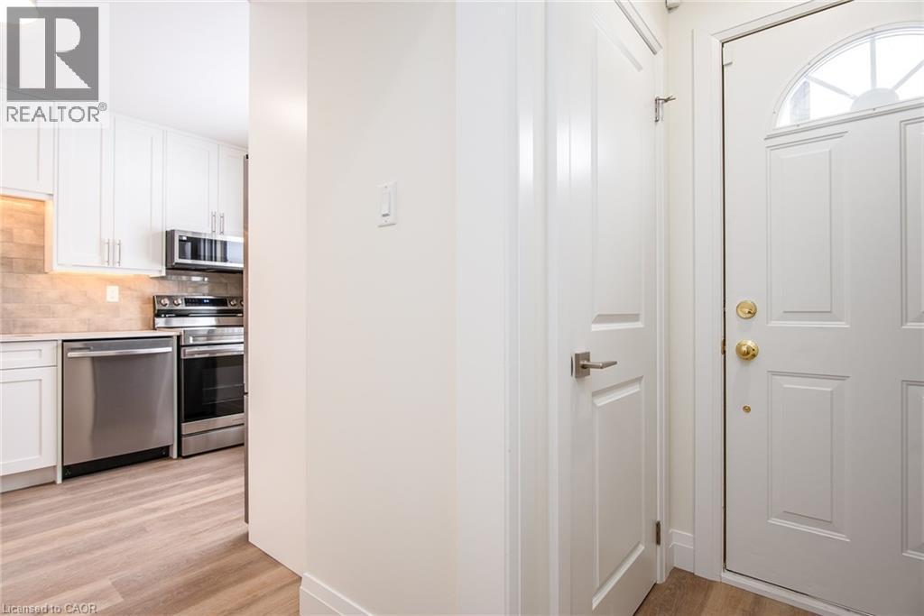 Foyer entrance featuring light wood-style floors - 27 Queenston Drive, Kitchener, ON - Indoor