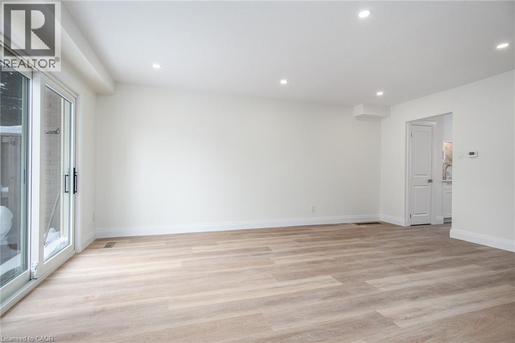 Empty room with light wood-style floors and recessed lighting - 27 Queenston Drive, Kitchener, ON - Indoor Photo Showing Other Room