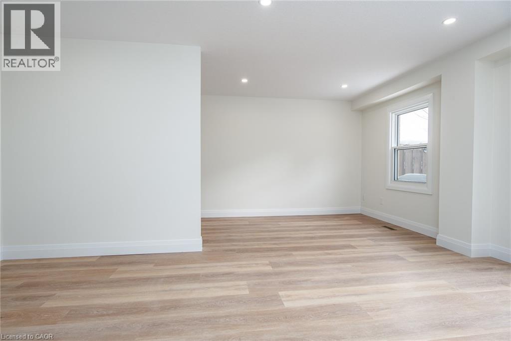 Empty room featuring light wood finished floors and recessed lighting - 27 Queenston Drive, Kitchener, ON - Indoor Photo Showing Other Room