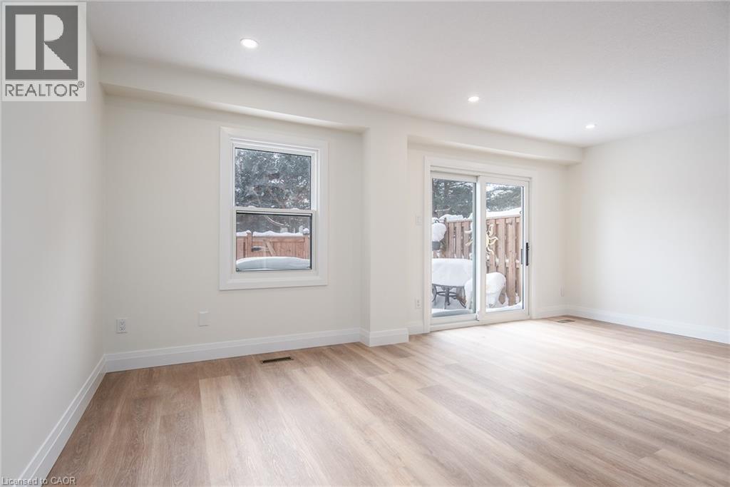 Empty room with light wood-type flooring and recessed lighting - 27 Queenston Drive, Kitchener, ON - Indoor Photo Showing Other Room