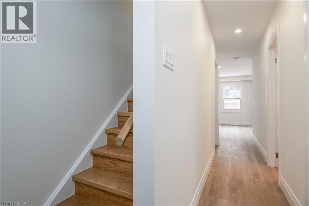 Hall with light wood finished floors, stairway, and recessed lighting - 27 Queenston Drive, Kitchener, ON - Indoor Photo Showing Other Room