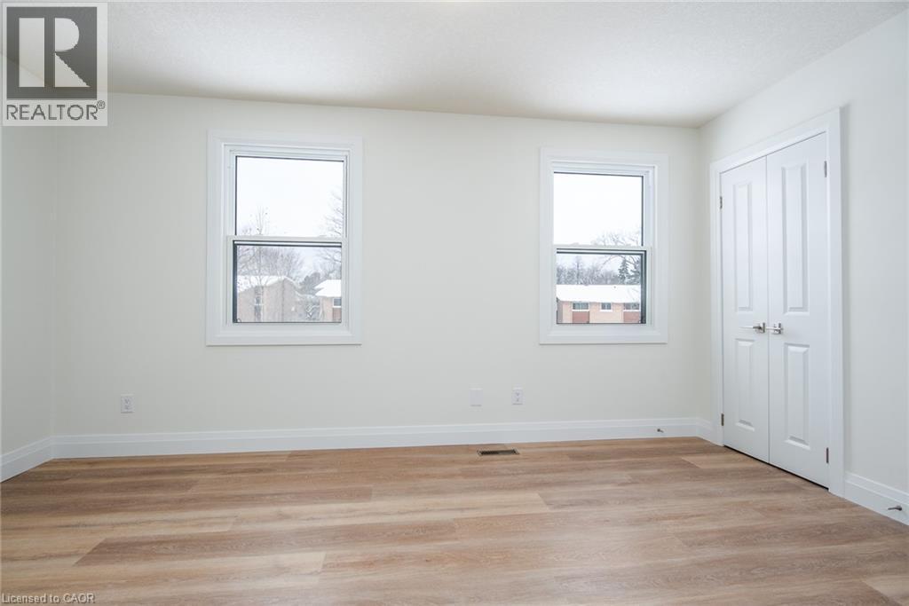 Unfurnished bedroom featuring light wood-style floors and a closet - 27 Queenston Drive, Kitchener, ON - Indoor Photo Showing Other Room