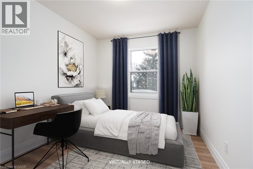 Bedroom featuring wood finished floors and a desk - 27 Queenston Drive, Kitchener, ON - Indoor Photo Showing Bedroom