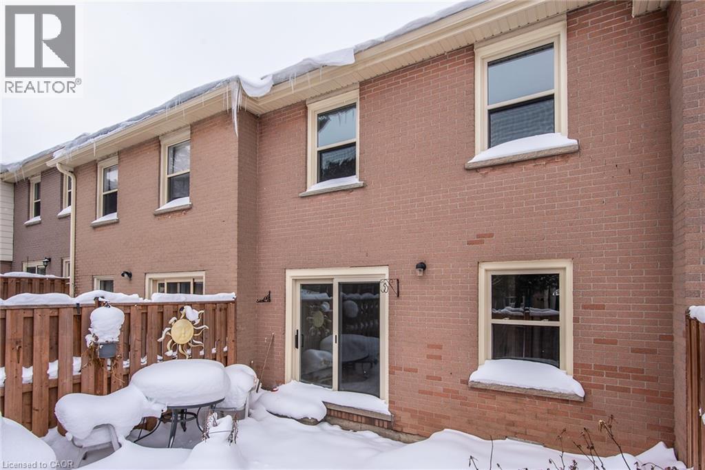 Snow covered property with brick siding - 27 Queenston Drive, Kitchener, ON - Outdoor With Exterior