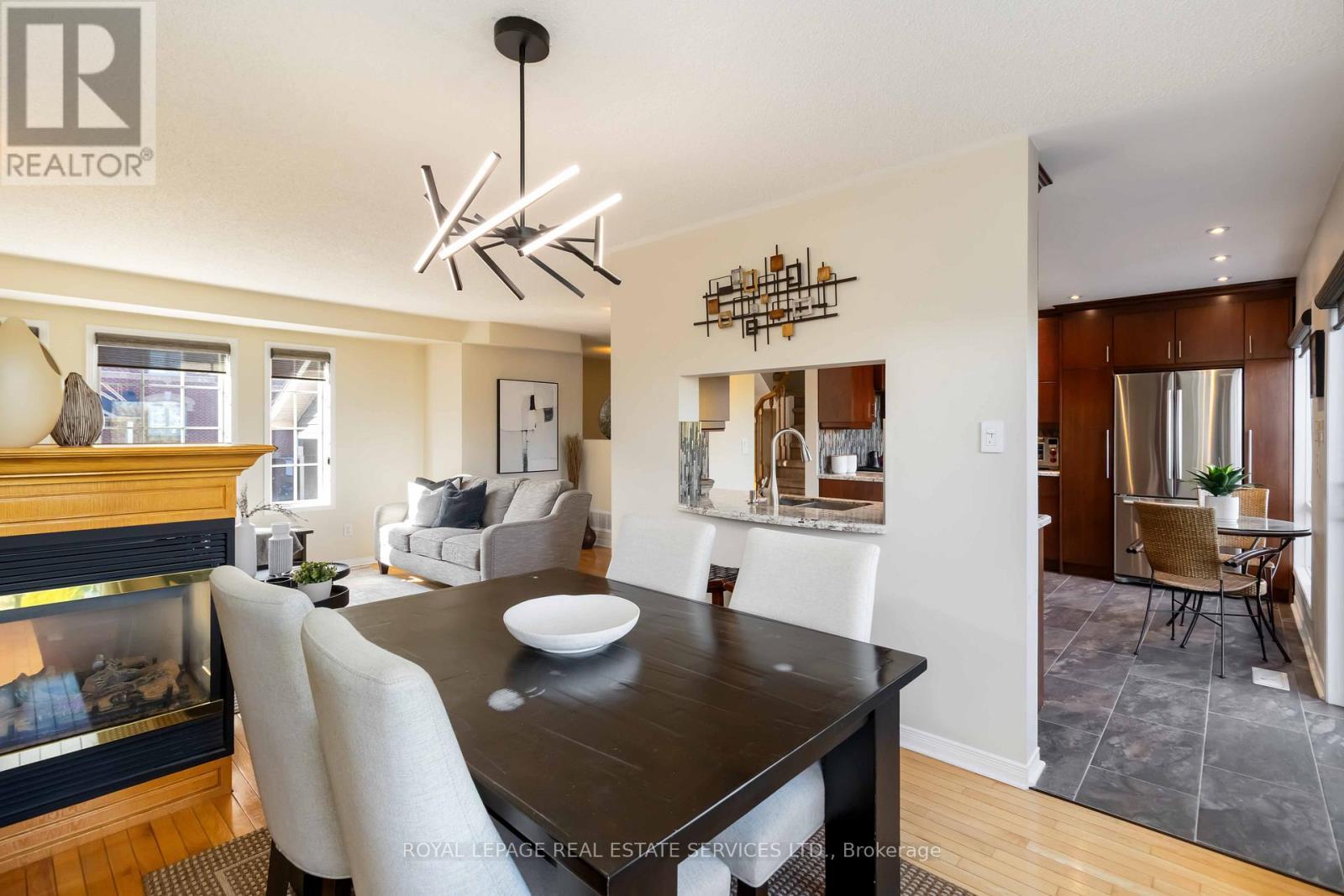 1584 Woodhenge Way, Mississauga, ON - Indoor Photo Showing Dining Room With Fireplace