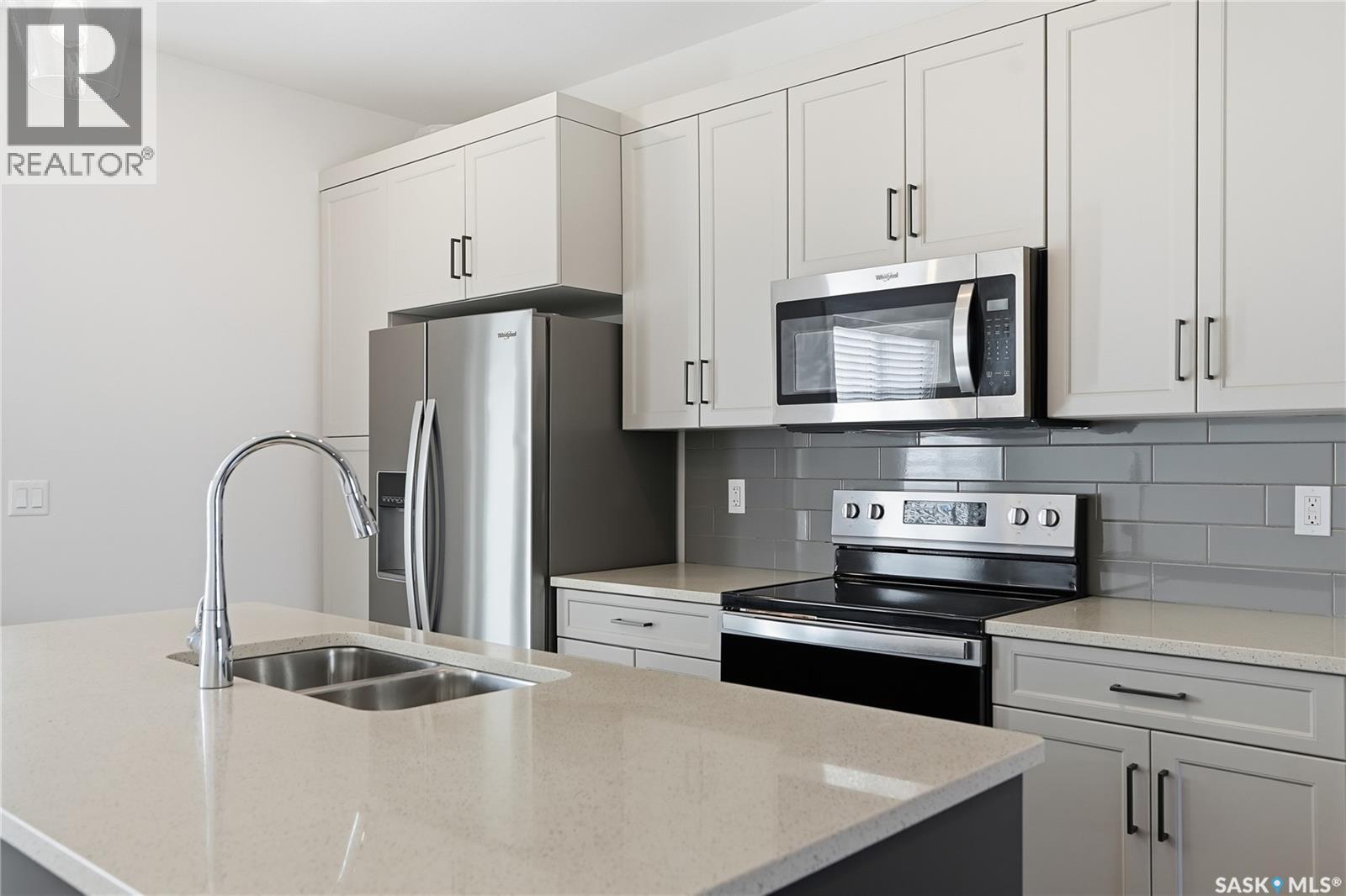966 Mcfaull Manor, Saskatoon, SK - Indoor Photo Showing Kitchen With Double Sink With Upgraded Kitchen