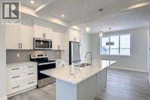 huge island, quartz countertops, - 253 Cobblestone Gate Sw, Airdrie, AB - Indoor Photo Showing Kitchen With Stainless Steel Kitchen With Upgraded Kitchen