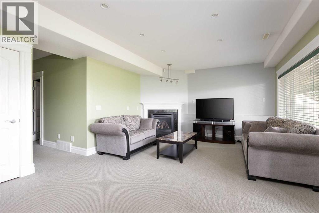 living room legal suite - 145 Fireweed Crescent, Fort Mcmurray, AB - Indoor Photo Showing Living Room With Fireplace